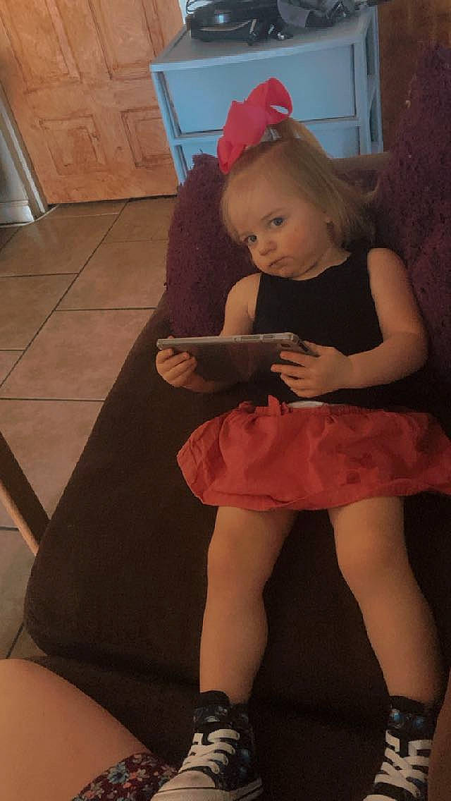 Haisley joined the competition — help win amazing prizes! blond, calf, dress, flash_photography, flooring, fun, human_body, human_leg, joint, knee, leg, long_hair, magenta, party_hat, person, pink, sitting, skin, thigh, toddler