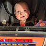Evelyn joined the competition — help win amazing prizes! baby, car_seat, child, smiling, toy, purple, face, infant, seatbelt, safety, bright_eyes, indoor, closeup, happy, person, portrait, shadow, light, cute, baby_toy