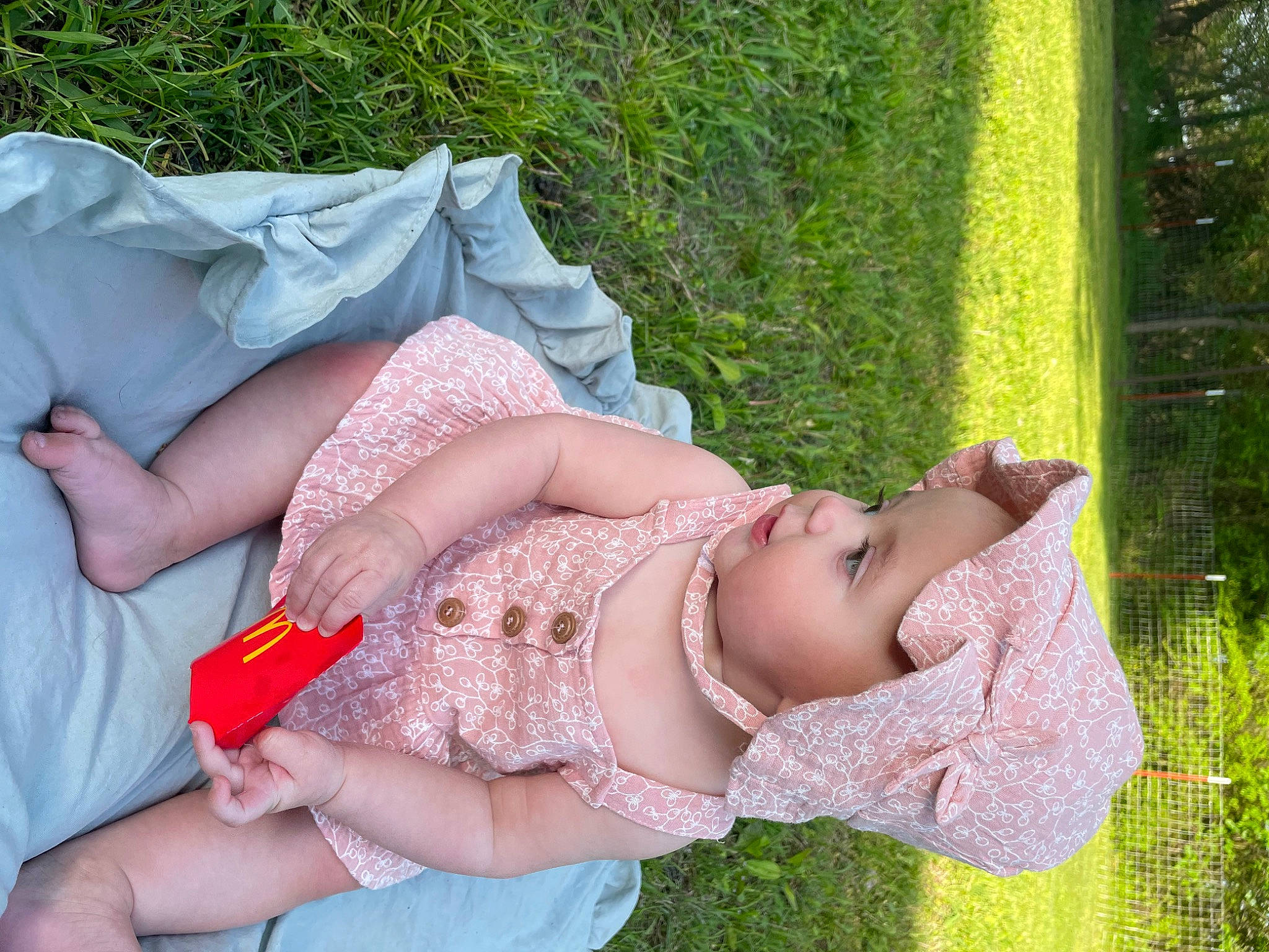 Chanel is registered to the contest to win money with this photo: abdomen, child, dress, flower, fun, gesture, grass, hand, happy, headwear, jewellery, leisure, necklace, people_in_nature, person, pink, plant, smile, summer, tree