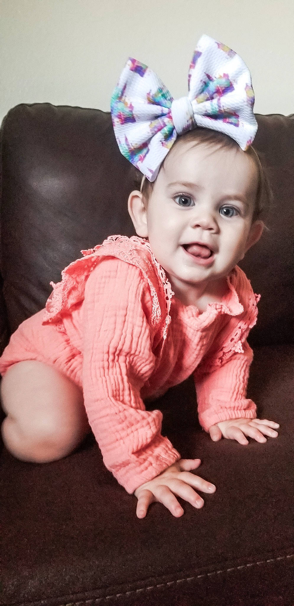 Averi is registered to the contest to win money with this photo: baby, baby_laughing, cheek, child, child_model, ear, fashion_accessory, hair_accessory, headgear, person, pink, smile, toddler