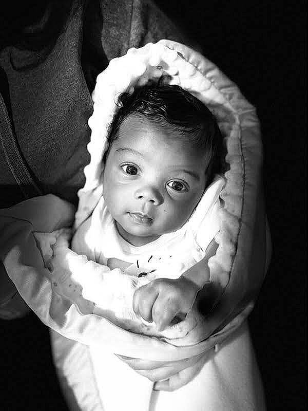 Jru is registered to the contest to win money with this photo: baby, baby_toddler_clothing, black_and_white, cheek, child, comfort, darkness, dress, eye, eyebrow, flash_photography, gesture, happy, lip, monochrome, monochrome_photography, person, sitting, sleeve, style