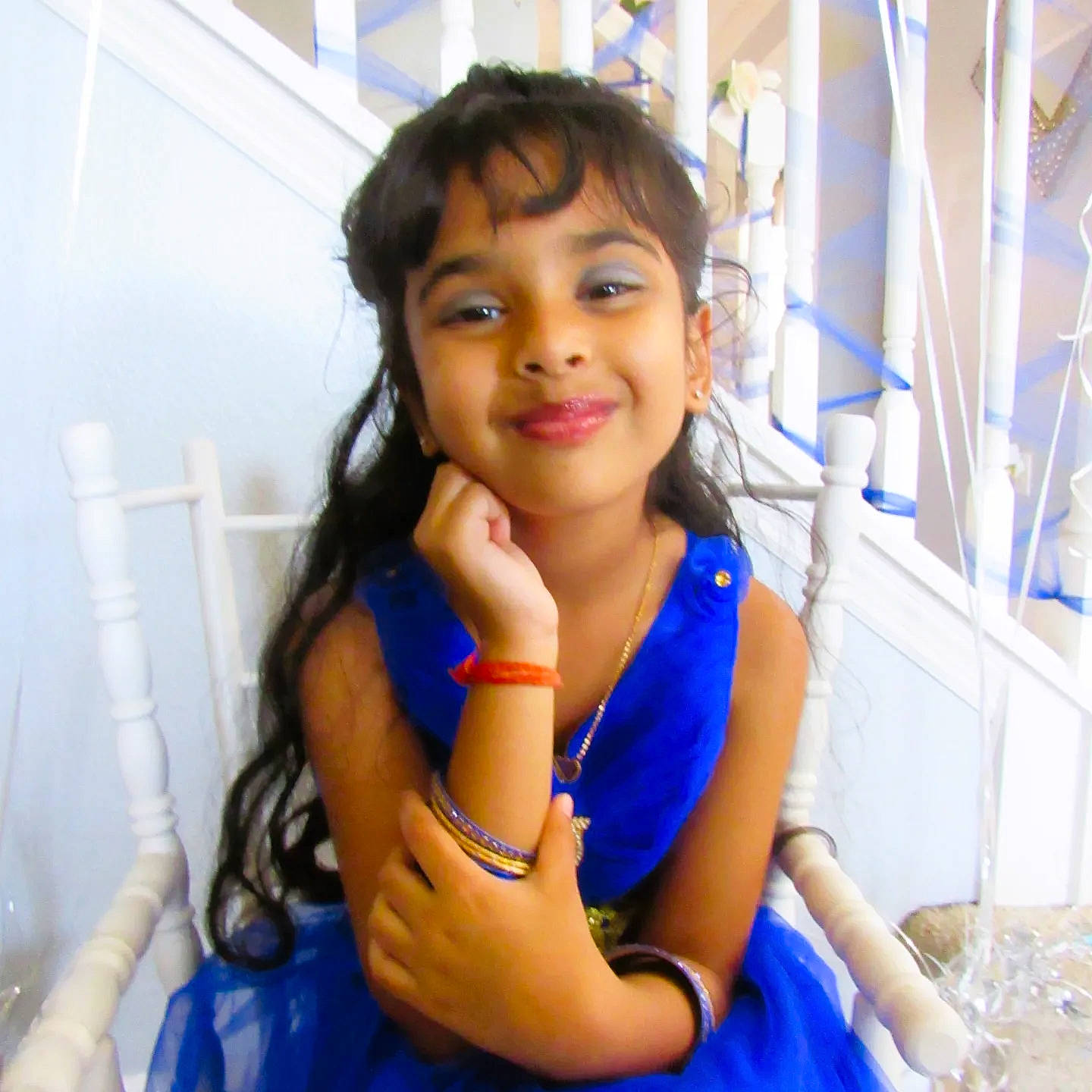 Kiara is registered to the contest to win money with this photo: arm, black_hair, cool, elbow, electric_blue, eye, eyebrow, finger, fun, gesture, happy, joy, leisure, person, shoulder, skin, smile, thigh, thumb, toddler