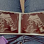 Ava is registered to the contest to win money with this photo: ultrasound, fetus, pregnancy, medical_image, jeans, denim, lap, person, photo, indoor, scan, baby, healthcare, pregnant, handheld, paper, blue, texture, focus, closeup