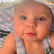 Ava is registered to the contest to win money with this photo: baby, child, face, hat, blue, striped, sunhat, clothing, cute, portrait, closeup, infant, smiling, skin, eyes, cheeks, person, indoors, window, light