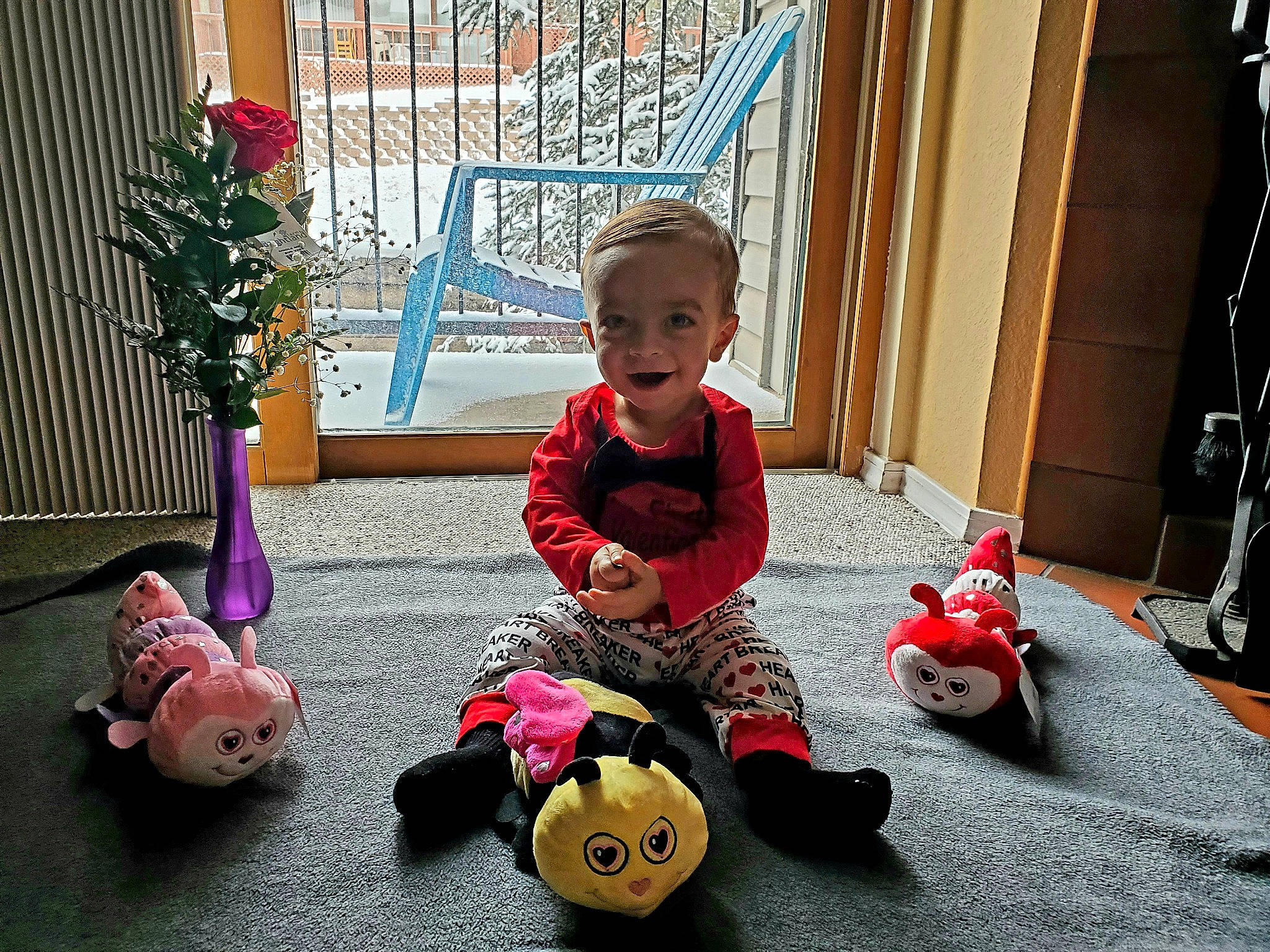 Huxton is registered to the contest to win money with this photo: baby, baby_products, baby_toddler_clothing, baby_toys, carmine, child, event, flooring, flowerpot, fun, houseplant, leisure, people, person, plant, play, sitting, smile, teddy_bear, toddler