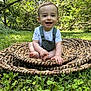 baby, child, smile, outdoor, grass, greenery, nature, woven_mat, sitting, happy, portrait, infant, cute, sunlight, trees, young, person, summer, playful, casual_clothing