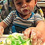 Robbie joined the competition — help win amazing prizes! toddler, child, cake, green_frosting, messy, high_chair, cream, face, hand, striped_shirt, indoor, kitchen, food, eating, birthday, smudged, closeup, young_child, frosting, celebration