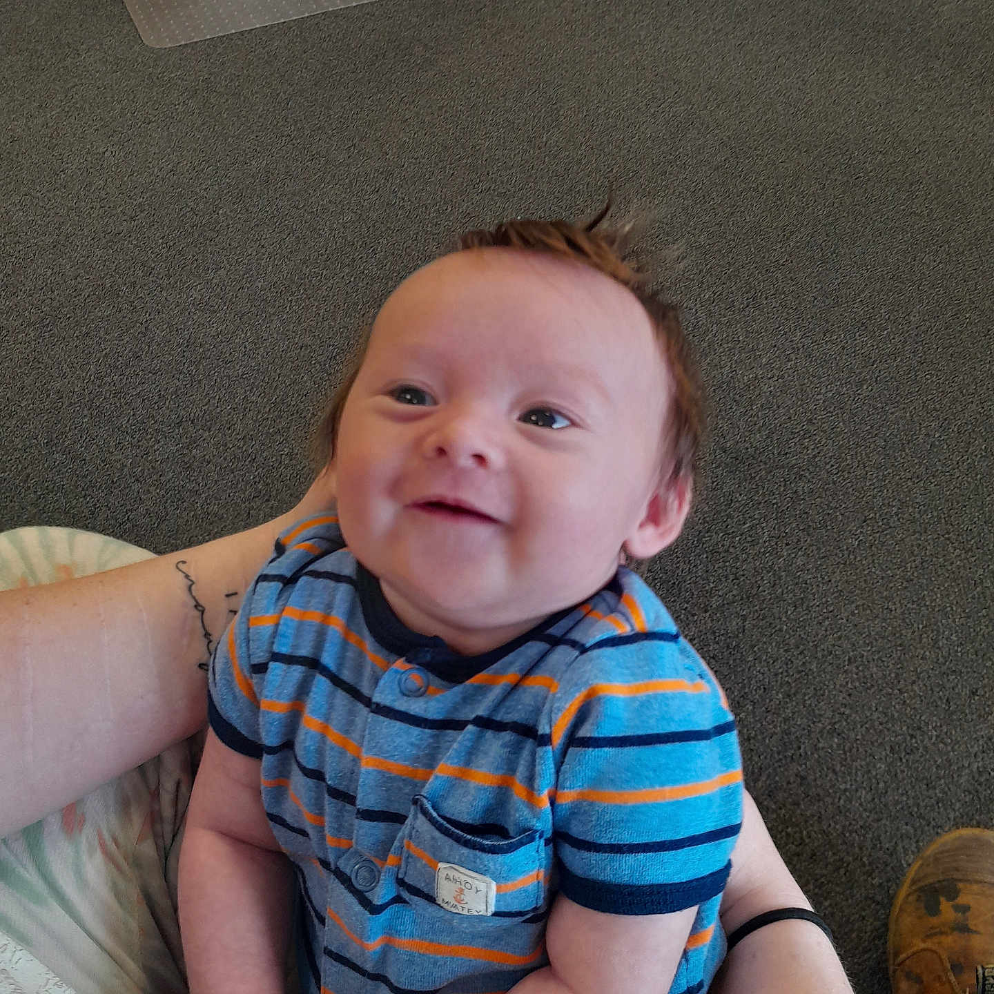 Phoenix is registered to the contest to win money with this photo: accessories, baby, bodypart, clothing, couch, face, finger, footwear, furniture, hand, head, homedecor, pants, person, photography, portrait, shoe, shorts, sitting, t_shirt