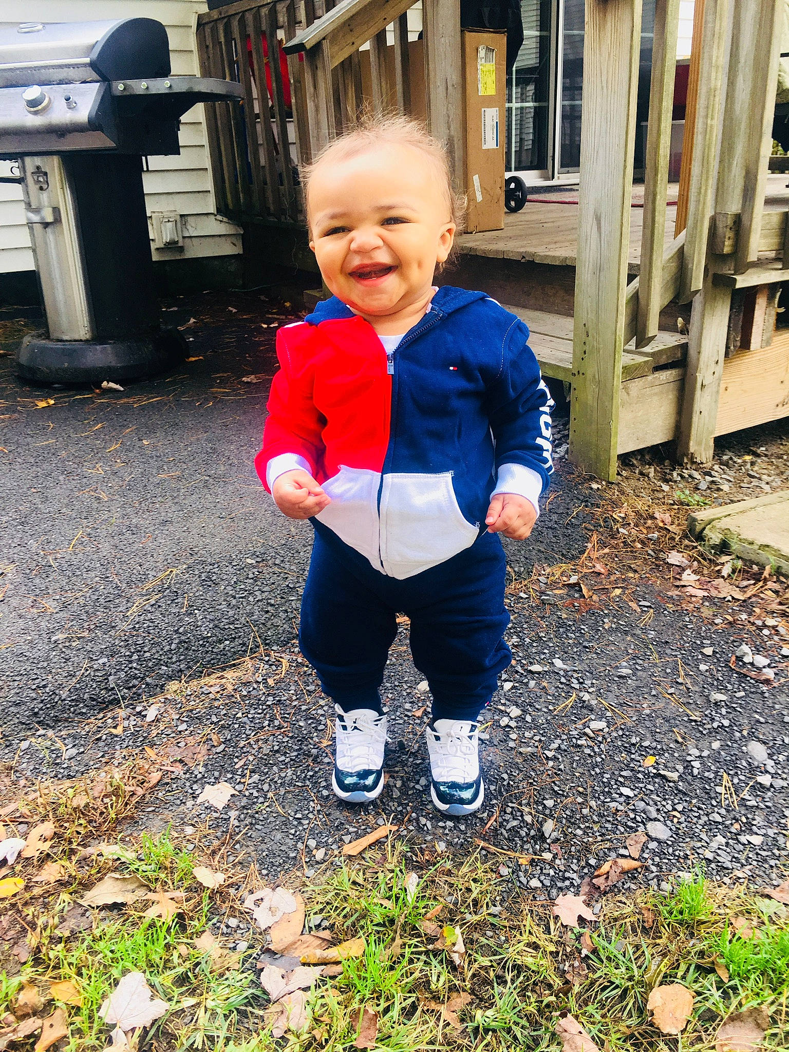 Denzel is registered to the contest to win money with this photo: blue, child, day, facial_expression, fun, girl, jeans, joy, outerwear, person, plant, play, recreation, red, smile, standing, toddler, vacation, winter