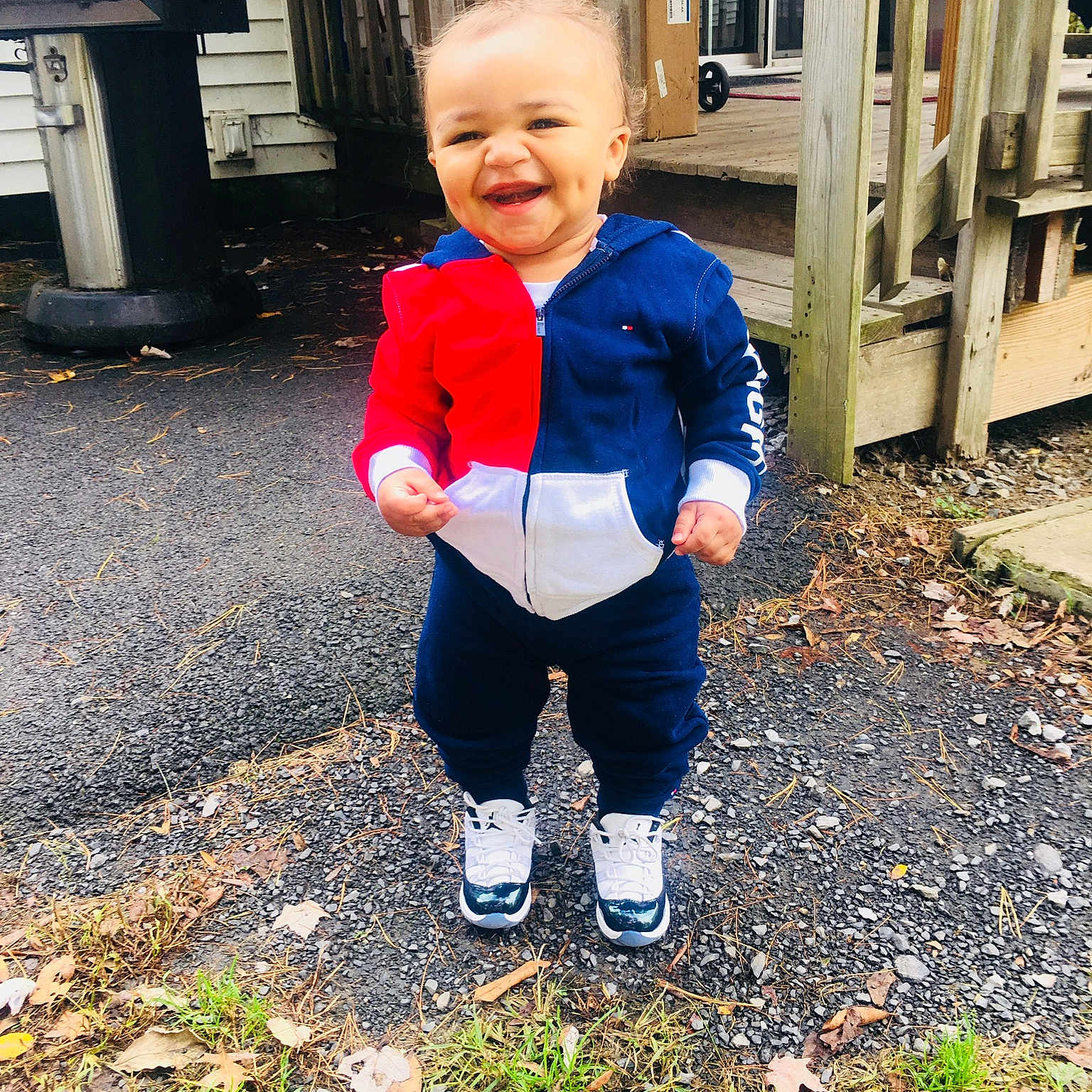 Denzel is registered to the contest to win money with this photo: blue, child, day, facial_expression, fun, girl, jeans, joy, outerwear, person, plant, play, recreation, red, smile, standing, toddler, vacation, winter