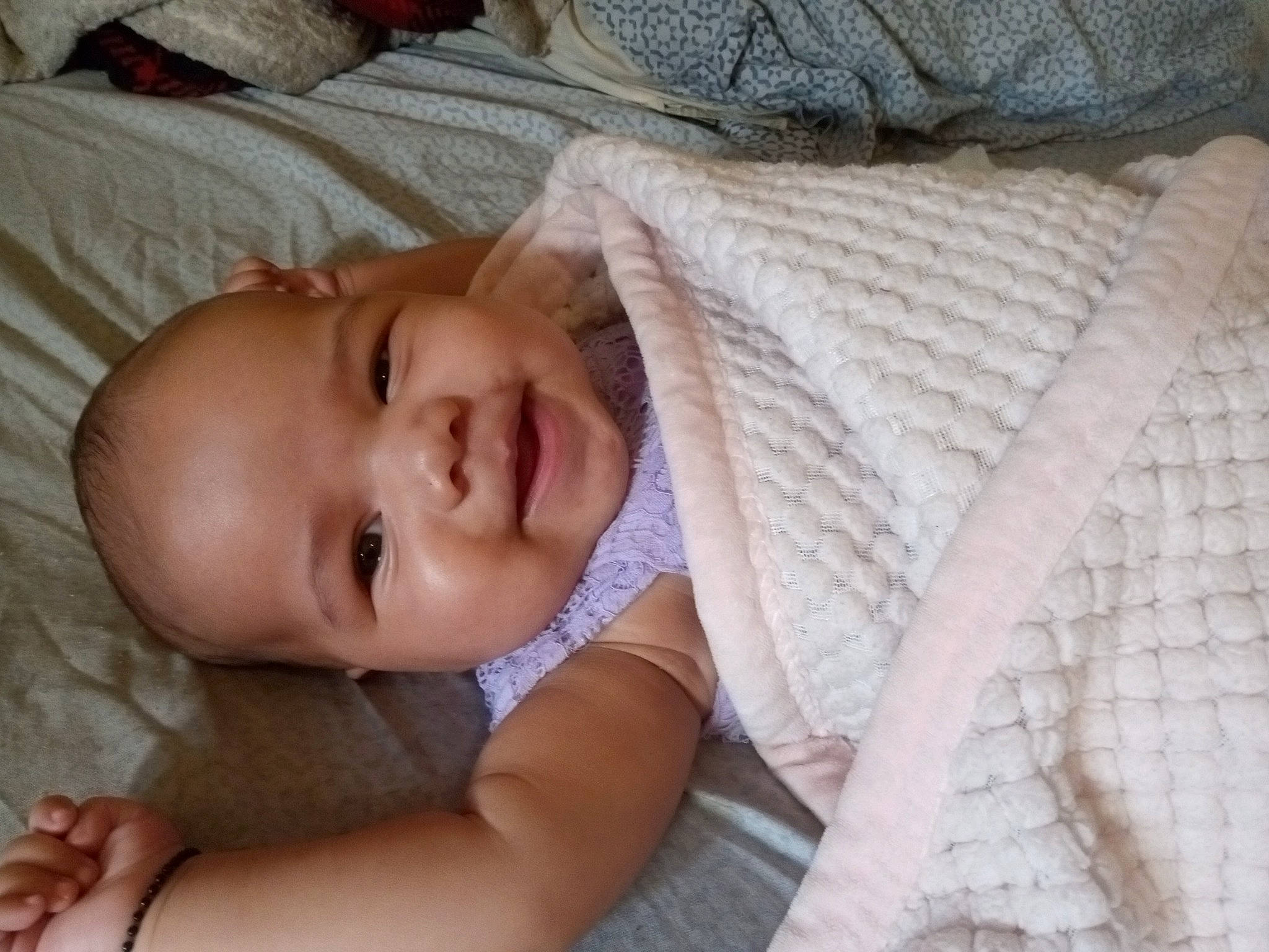 Serenity is registered to the contest to win money with this photo: baby, baby_products, baby_toddler_clothing, bedtime, cheek, child, close_up, comfort, eye, grass, happy, head, iris, linens, lip, nose, person, skin, sleeve, smile