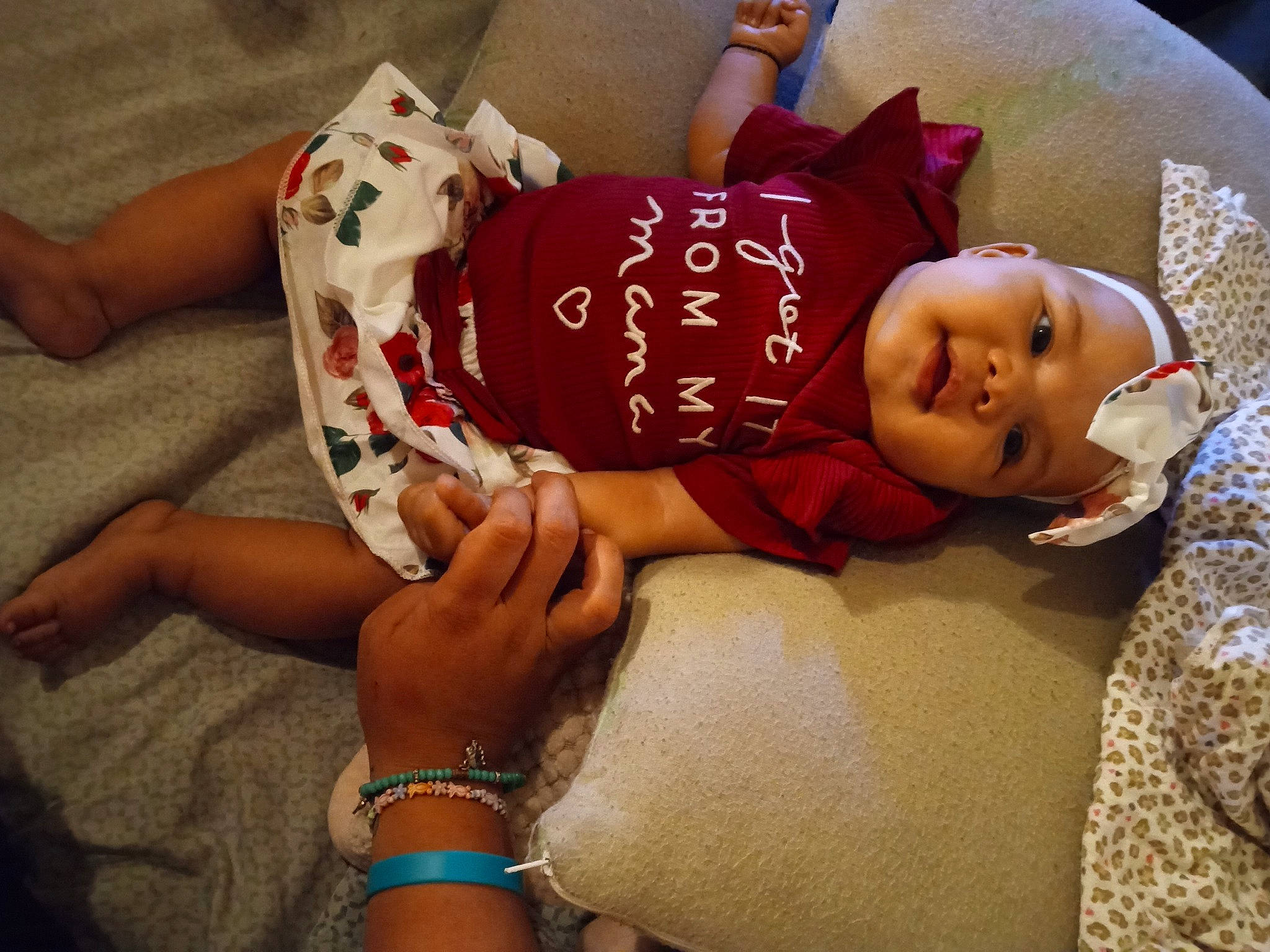 Serenity is registered to the contest to win money with this photo: child, comfort, doll, event, finger, foot, happy, hat, headwear, human_leg, jewellery, knee, lap, nail, person, sitting, skin, textile, thigh, toddler