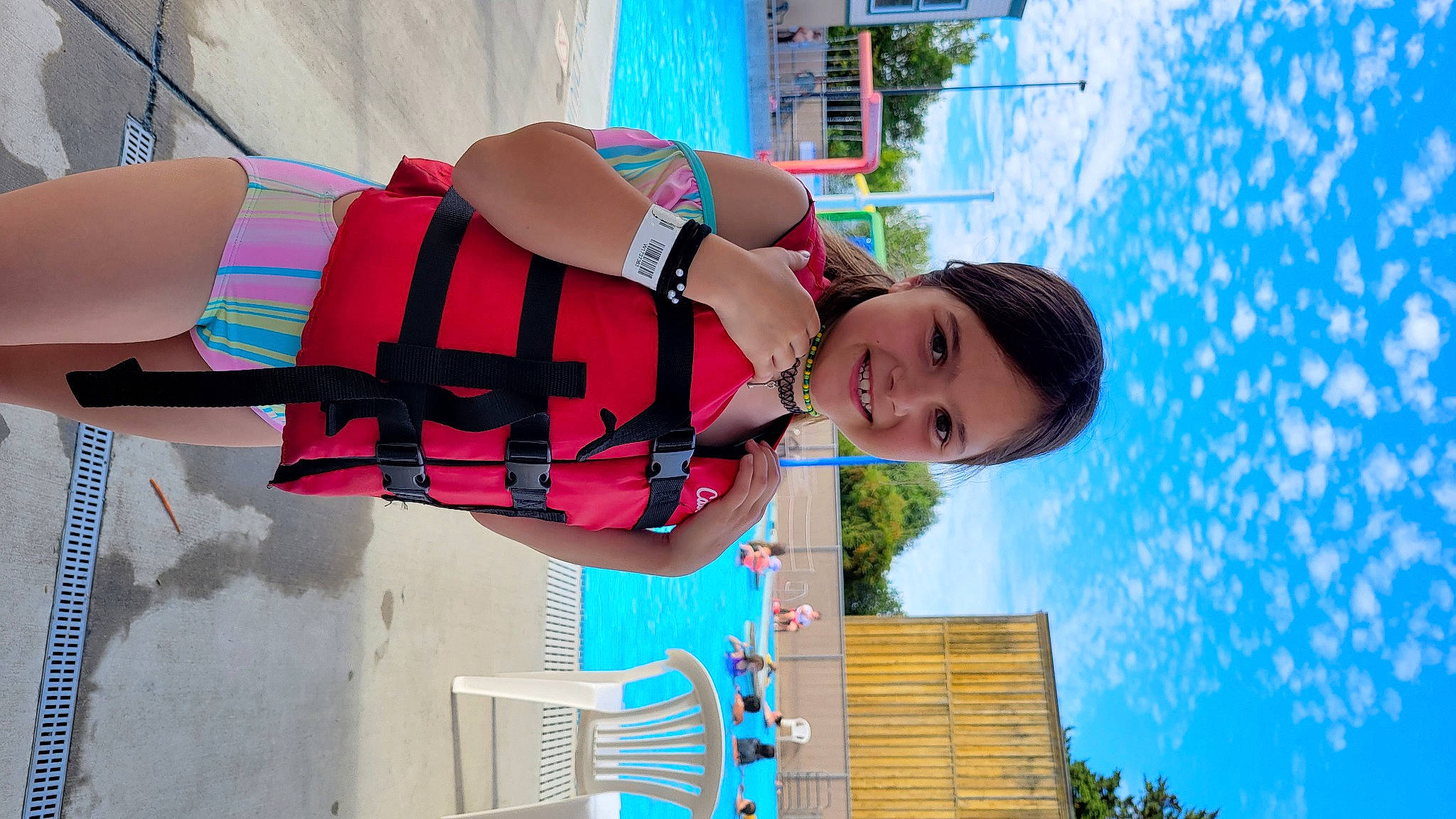 Paisley is registered to the contest to win money with this photo: blue, child, elbow, electric_blue, eyewear, fashion_accessory, fun, happy, human_leg, joy, leisure, magenta, pattern, person, pink, sky, thigh, travel, tree, vacation