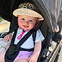 Elise participe au concours pour gagner de l'argent avec cette photo : baby, child, smiling, hat, stroller, sunlight, outdoor, cute, happy, face, clothing, seatbelt, blanket, pink_shorts, leopard_print, person, infant, summer, safety, portrait