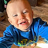 Kayden is registered to the contest to win money with this photo: toddler, child, smiling, blue_sweater, barefoot, indoor, wooden_floor, happy, cute, baby, face, person, clothing, floor, standing, young_child, portrait, casual, playful, head