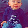 baby, child, couch, cozy, cute, expression, face, furniture, hair, hand, indoors, infant, jeans, portrait, shirt, sitting, smile, striped_socks, text_on_clothing, young_child