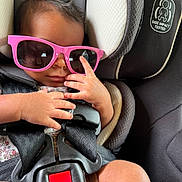 Serenity joined the competition — help win amazing prizes! baby, sunglasses, car_seat, child, infant, hands, safety_harness, pink, cool, cute, seatbelt, closeup, portrait, fashion, accessory, relaxing, young, person, expression, indoor