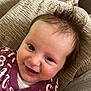 Robyn is registered to the contest to win money with this photo: baby, smiling, face, hair, onesie, numbers, cushion, texture, closeup, joyful, expression, infant, skin, head, person, happy, cute, child, portrait, indoor