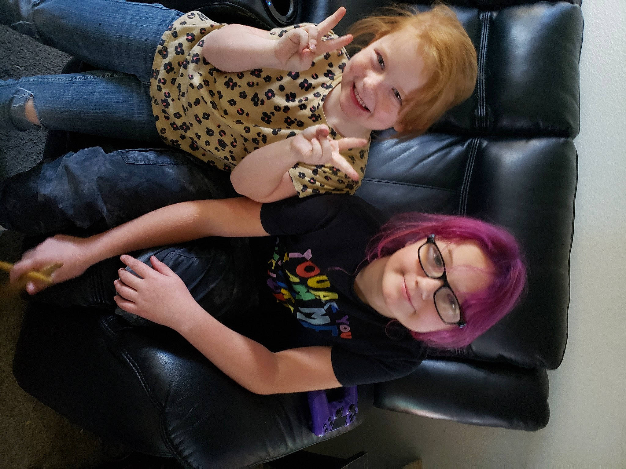 Rebel is registered to the contest to win money with this photo: arm, clothing, comfort, cool, face, facial_expression, fun, gesture, hair, hand, happy, head, interaction, joint, joy, lap, leg, mammal, person, purple