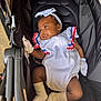 baby, black_hair, bow, car_seat, child, comfort, cute, headband, indoors, infant, mittens, newborn, peaceful, portrait, relaxing, sleepy, socks, soft_lighting, stroller, white_outfit