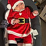 Anaëlle participe au concours pour gagner de l'argent avec cette photo : baby, infant, santa_claus_outfit, red_clothing, hat, black_belt, baby_seat, indoors, holiday, christmas, cute, child, cozy, portrait, face, person, footwear, furniture, expression, newborn