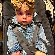 Alera joined the competition — help win amazing prizes! baby, blue_eyes, bow_headband, casual_wear, child, clothing, curious, cute, denim_jacket, face, fashion, headwear, indoors, infant, person, portrait, seated, straps, stroller, young_child