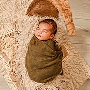 Ravi is registered to the contest to win money with this photo: baby, blanket, child, cozy, cushion, cute, decor, indoors, infant, neutral_colors, newborn, peaceful, portrait, resting, sleeping, soft_texture, swaddle, wicker, wooden_floor, wrapped
