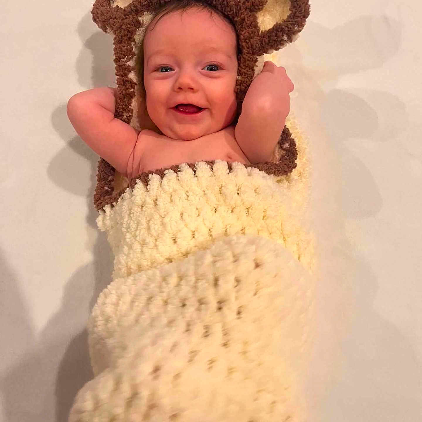 Christine Briggs joined the competition — help win amazing prizes! baby, infant, child, portrait, smiling, happy, face, eyes, indoors, blanket, plush, teddy_bear, animal_ears, costume, cozy, lying_down, nursery, soft_lighting, close_up, photography