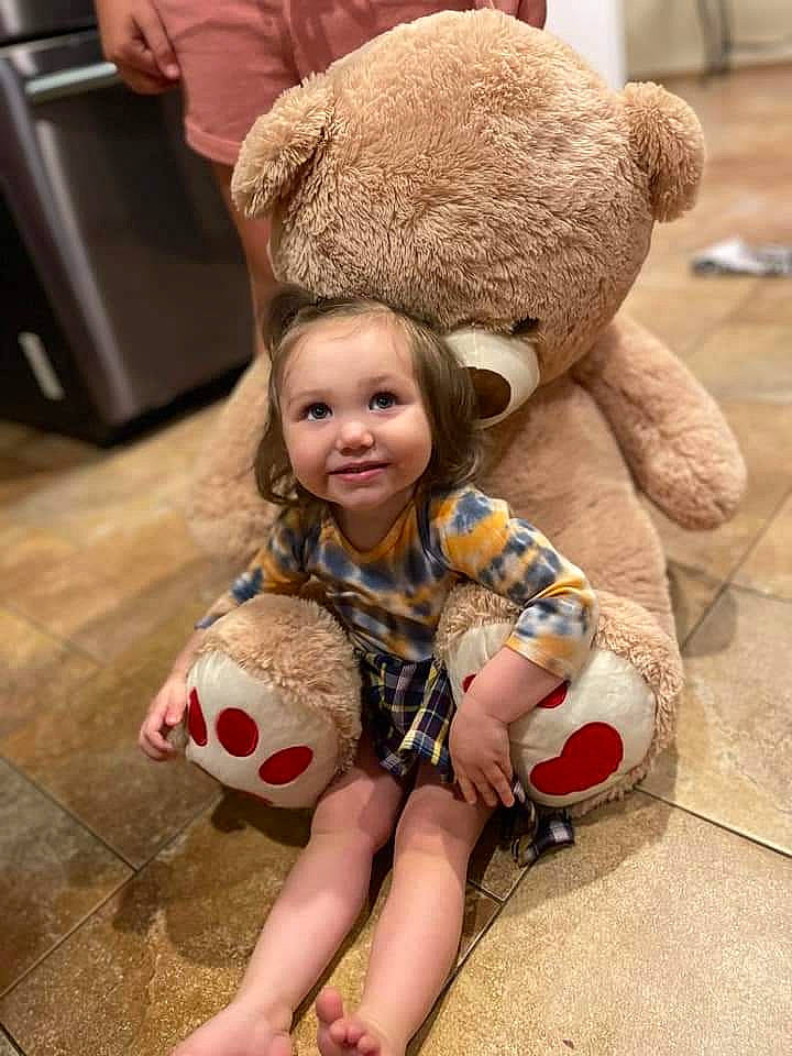 Novalynn joined the competition — help win amazing prizes! baby, ball, cap, child, fawn, flooring, football, fun, fur, happy, headgear, human_body, human_leg, joy, pattern, person, skin, stuffed_toy, teddy_bear, thigh