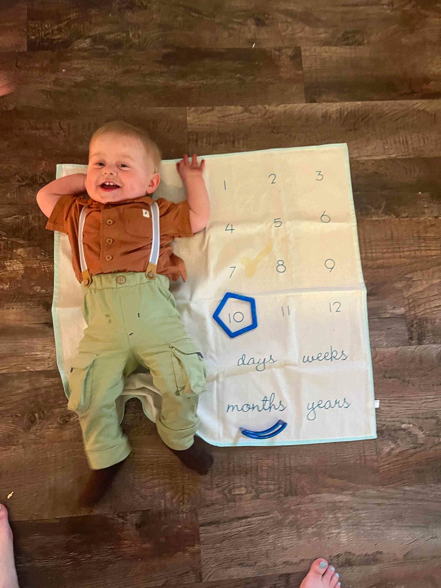 Michael is registered to the contest to win money with this photo: baby, baby_toddler_clothing, cardboard, child, finger, floor, flooring, foot, fun, happy, hardwood, packaging_and_labeling, people_in_nature, person, play, shipping_box, sitting, smile, soil, toddler