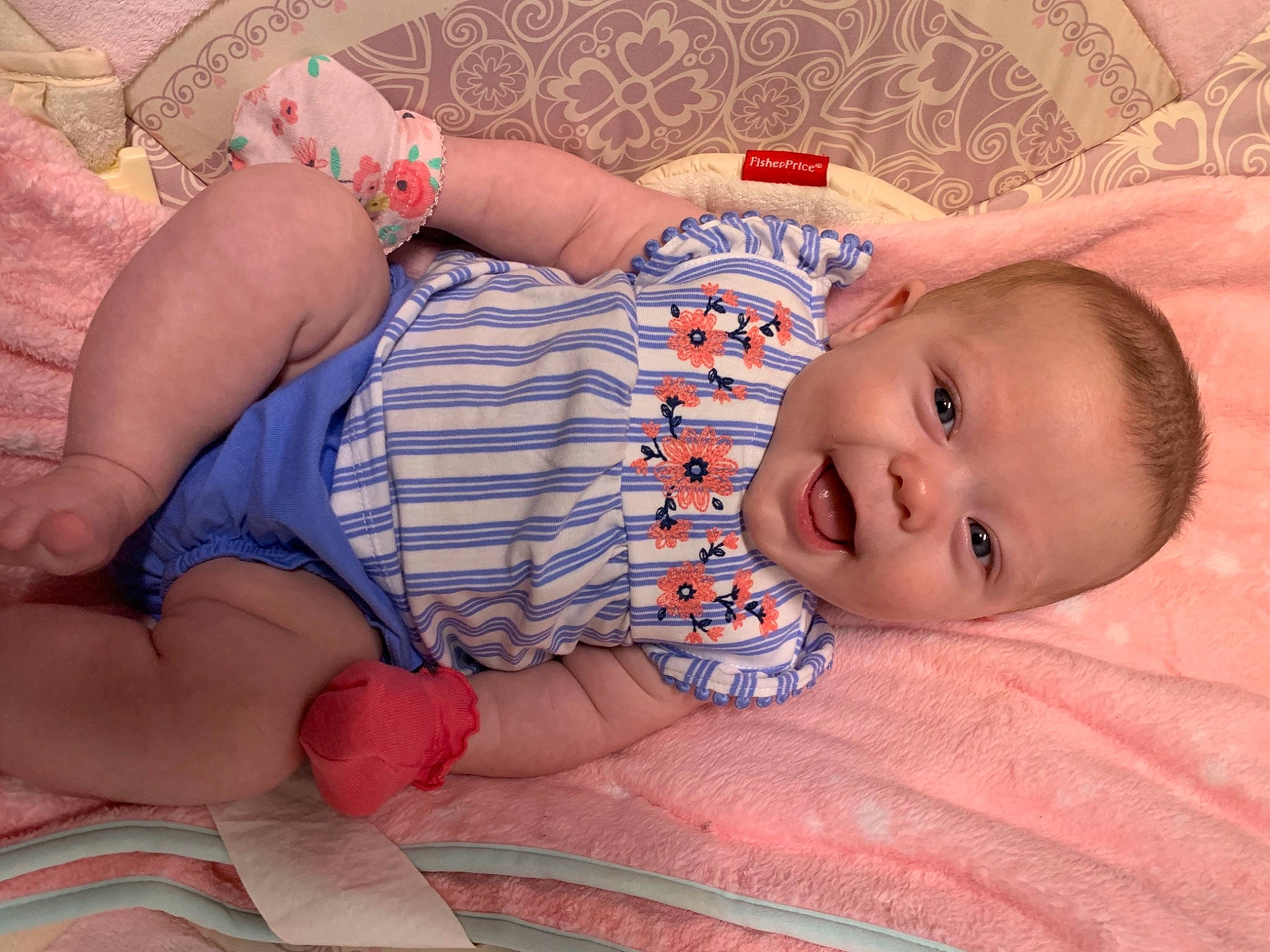 Annalee is registered to the contest to win money with this photo: baby, baby_toddler_clothing, cheek, comfort, facial_expression, finger, hairstyle, human_body, iris, linens, lip, mouth, nose, person, pink, skin, smile, stomach, textile, thigh