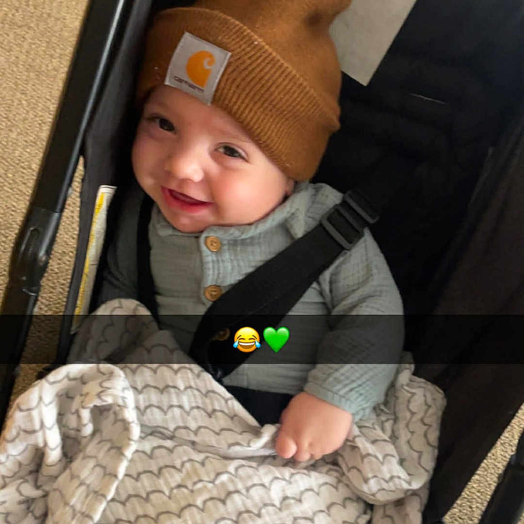 Skylo joined the competition — help win amazing prizes! baby, beanie, blanket, buttoned_shirt, car_seat, carpet, cheeky_grin, child, cozy, cute, emoji_overlay, happy, hat, indoors, infant, plush_blanket, portrait, seatbelt, smile, stroller