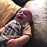 Skylo joined the competition — help win amazing prizes! baby, blurred, casual, child, clothing, couch, cozy, face, hand, happy, head, indoor, infant, person, pillow, relaxing, smiling, soft_lighting, striped_shirt, young_child