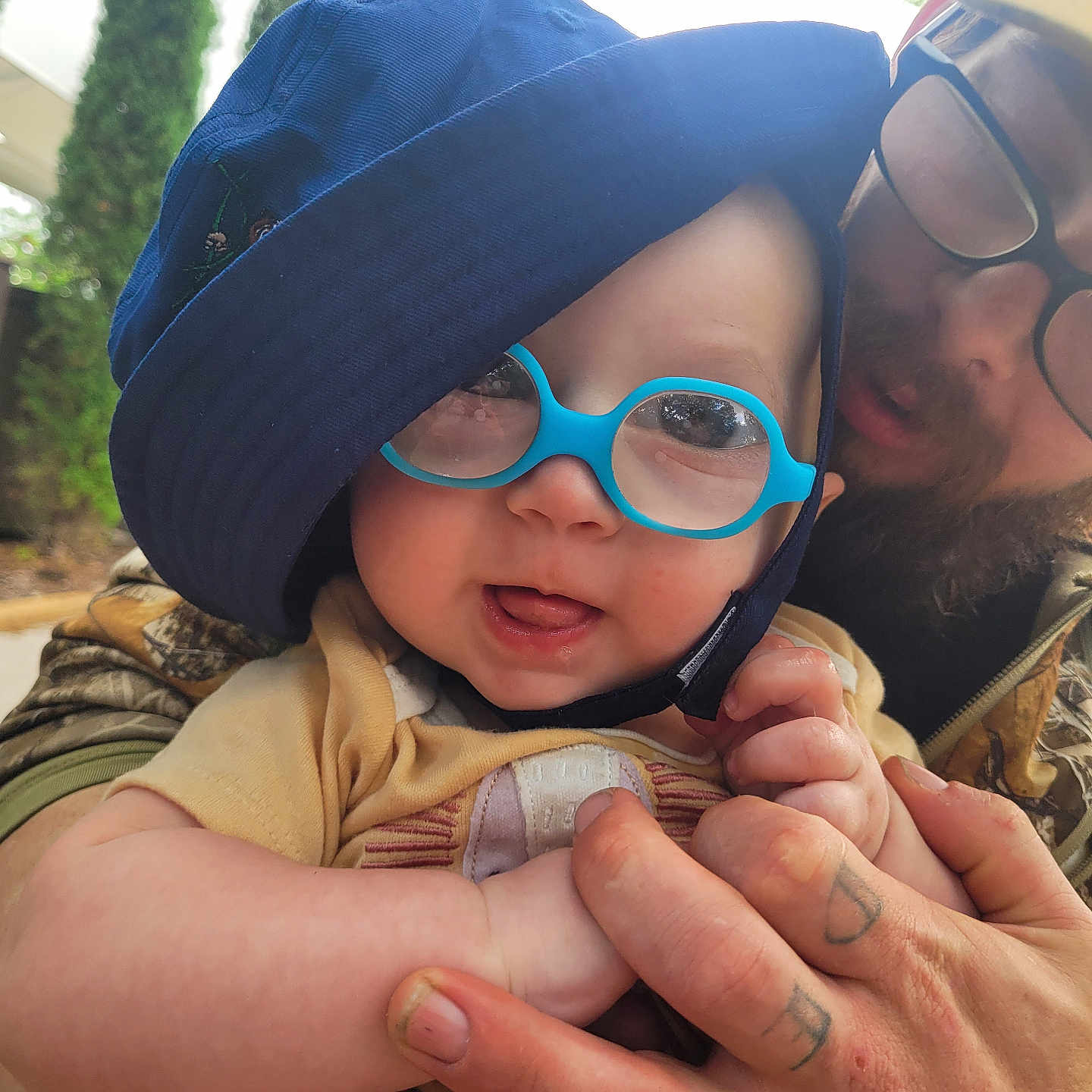 Harrison is registered to the contest to win money with this photo: accessories, baby, baseballcap, bodypart, cap, clothing, face, finger, glasses, hand, hat, head, jewelry, person, photography, portrait, ring, skin, sunglasses, tattoo
