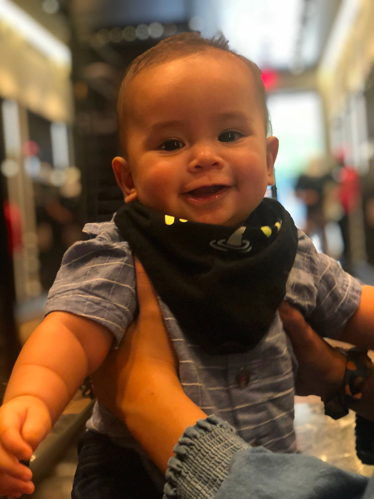 Tanner is registered to the contest to win money with this photo: baby, cheek, child, cool, elbow, facial_expression, flooring, fun, gesture, hand, happy, organ, person, personal_protective_equipment, sitting, skin, sleeve, smile, t_shirt, thumb