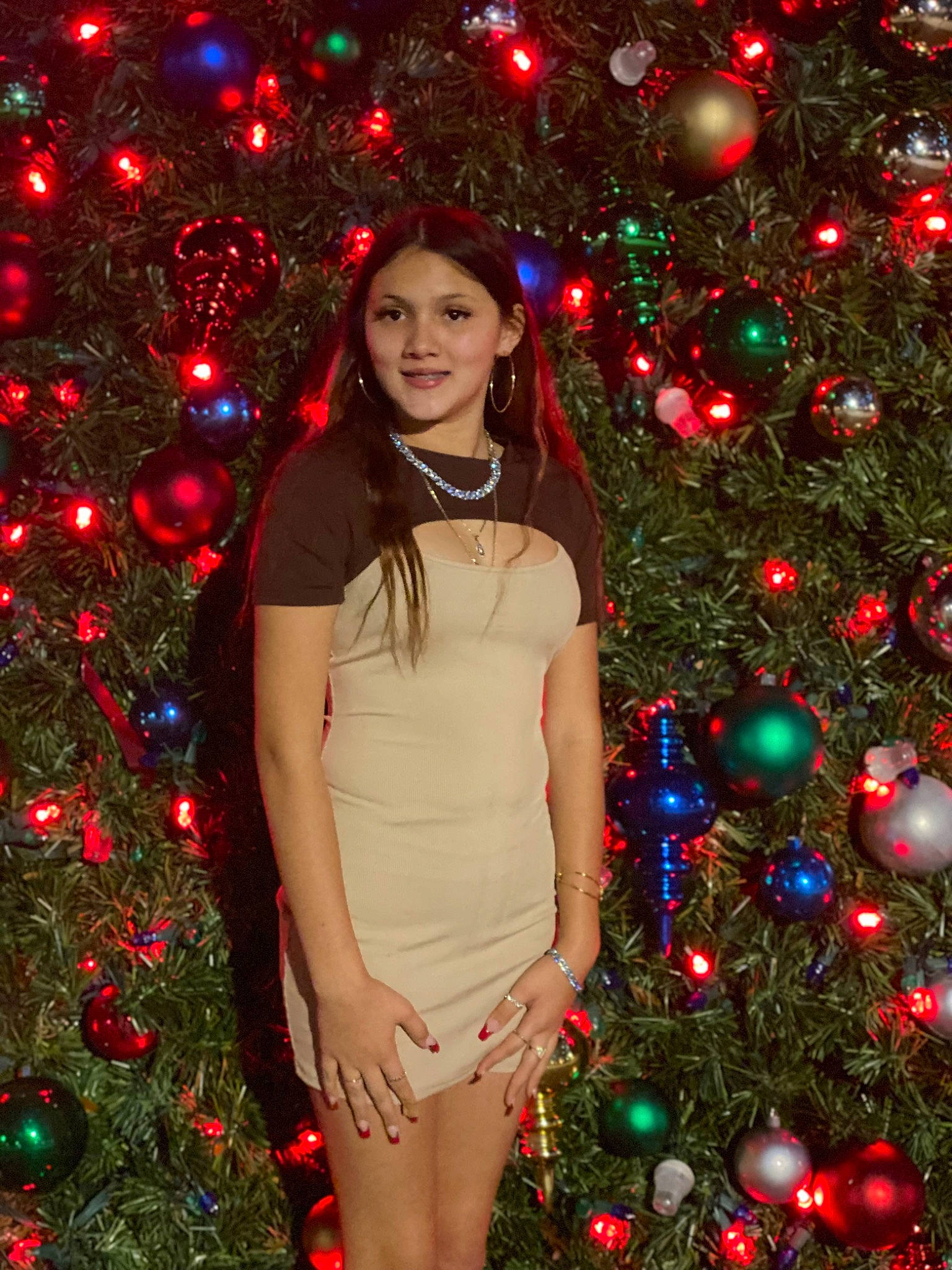 Yesenia joined the competition — help win amazing prizes! christmas_decoration, christmas_ornament, christmas_tree, facial_expression, green, hair, happy, head, holiday_ornament, human_body, joy, light, lighting, nature, ornament, person, plant, red, smile, standing