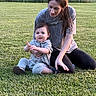 Haizen is registered to the contest to win money with this photo: care, casual_clothing, child, daylight, family, female, field, grass, greenery, happy, leisure, nature, outdoor, parent, people, portrait, sitting, smile, toddler, woman