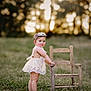 baby, barefoot, child, cute, field, flower_crown, grass, greenery, innocence, lace_dress, nature, outdoor, portrait, smiling, standing, summer, sunset, toddler, wooden_chair, young_child