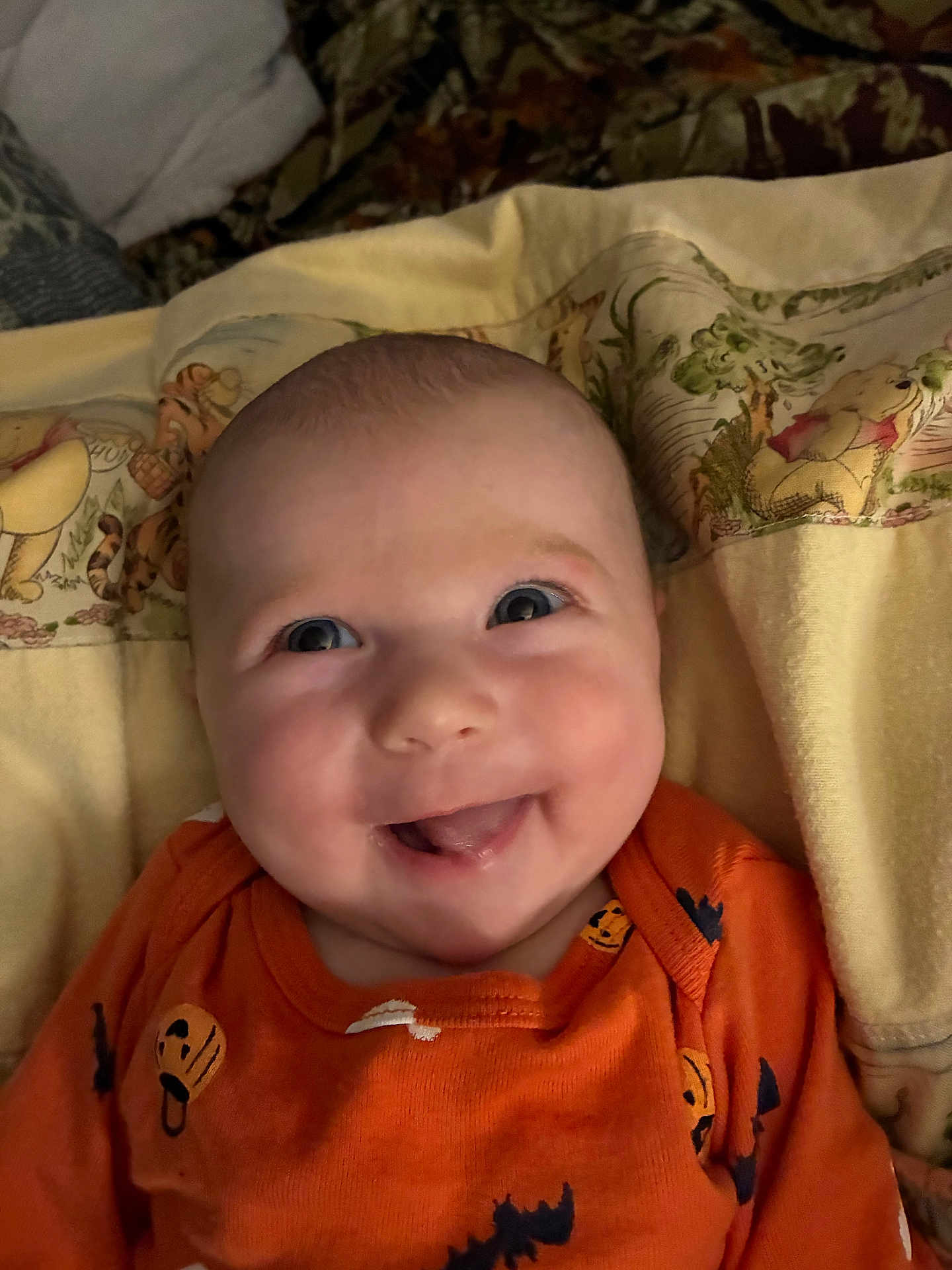 Kinsleigh is registered to the contest to win money with this photo: baby, smiling, orange_clothing, pumpkin_pattern, blanket, winnie_the_pooh, tiger, toddler, face, happy, portrait, child, cute, indoors, cozy, expression, infant, person, head, clothing
