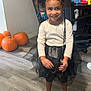 Molli joined the competition — help win amazing prizes! child, girl, smiling, barefoot, black_bow, curly_hair, tutu, white_shirt, pumpkins, wooden_floor, indoor, home, flooring, decor, flowers, bag, furniture, portrait, happy, cute