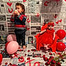 Ila Rose joined the competition — help win amazing prizes! child, toddler, baby, red_dress, balloon, rose_petals, newspaper_background, handprints, heart_symbols, cupcake, red_chair, barefoot, headband, valentines_theme, indoor, floor, smile, standing, sitting, portrait