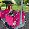 animal, canine, daylight, dog, fun, grass, happy, harness, nature, outdoor, park, pet, pink, play_equipment, playground, recreation, smiling, train, trees, vehicle