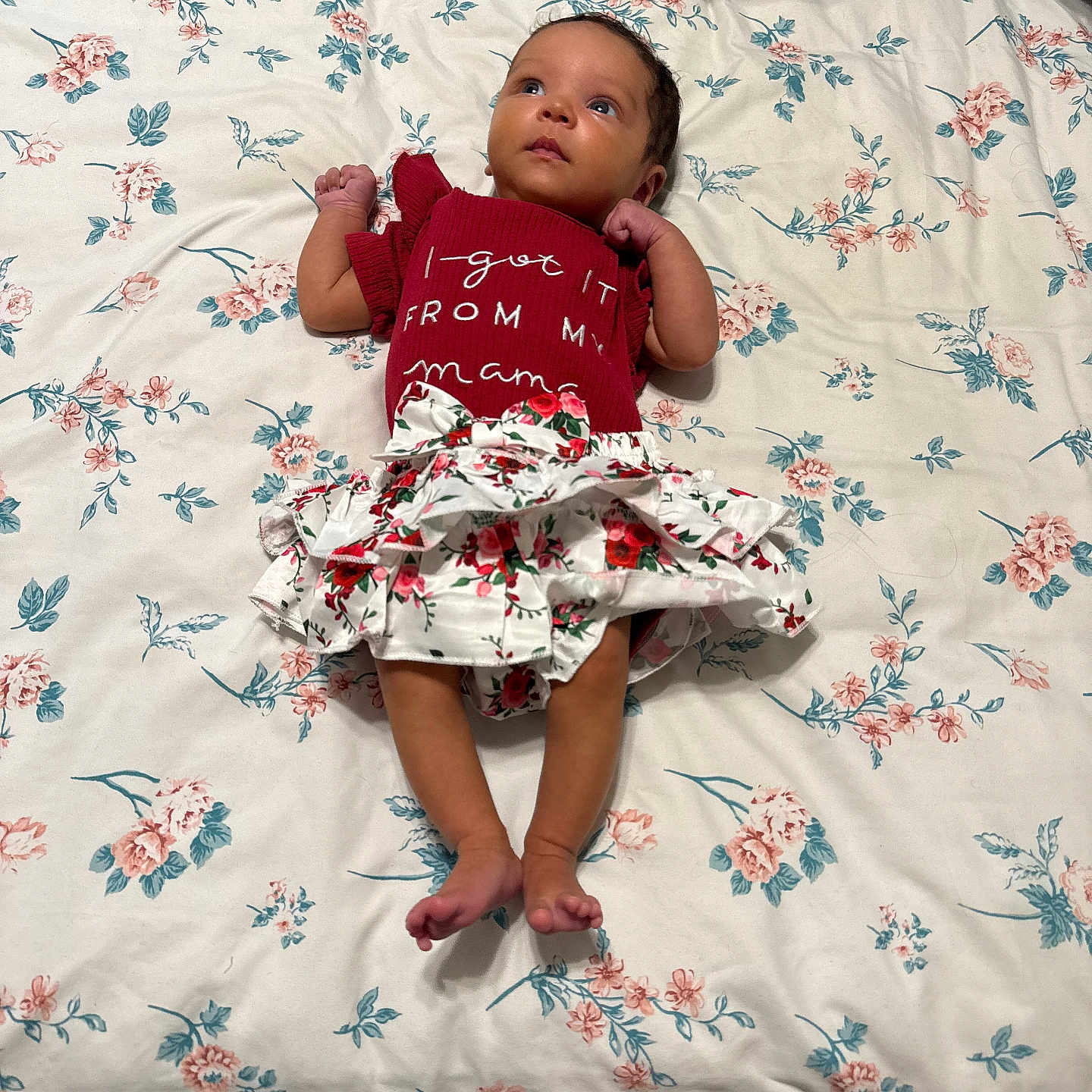 Kenlee Grayce joined the competition — help win amazing prizes! baby, infant, child, lying_down, floral_pattern, bedspread, red_clothing, skirt, cute, indoors, person, looking_up, barefoot, fabric, soft_lighting, comfortable, young, sleepwear, skin, head