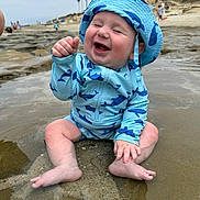 Jackson joined the competition — help win amazing prizes! baby, child, smiling, beach, water, swimsuit, hat, sunhat, sandy, palm_trees, ocean, happy, sitting, toddler, playful, summer, outdoor, nature, fun, vacation