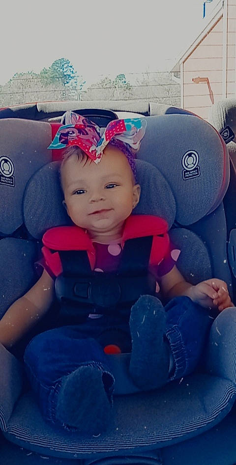 Thyri is registered to the contest to win money with this photo: auto_part, automotive_design, baby_products, baby_toddler_clothing, blue, car_seat, car_seat_cover, child, comfort, cool, electric_blue, fun, happy, lap, leisure, person, personal_protective_equipment, product, steering_wheel, toddler