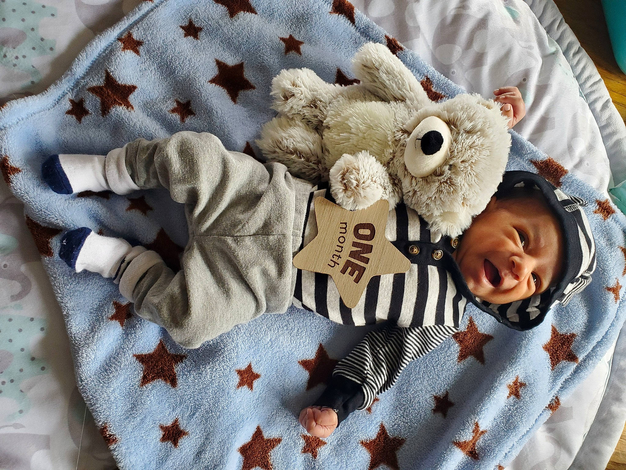 Kamden is registered to the contest to win money with this photo: baby, baby_products, baby_sleeping, baby_toddler_clothing, bed_sheet, bedding, child, comfort, event, fur, happy, headwear, linens, pattern, person, room, sleeve, smile, toddler, white