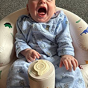 Rio joined the competition — help win amazing prizes! baby, baby_seat, blue_pajamas, bottle_holder, carpet, child, comfort, crying, cute, expression, footwear, home, indoor, infant, pattern, person, sitting, sock, yawning, young_child