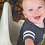 Dustin joined the competition — help win amazing prizes! baby, high_chair, smile, blue_eyes, happy, indoor, child, toddler, clothing, short_sleeve, person, furniture, wood_floor, playful, cute, infant, portrait, young_child, joyful, reaching_hand