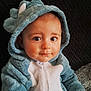 Livaï participe au concours pour gagner de l'argent avec cette photo : baby, child, onesie, hood, blue, white, dinosaur_costume, cute, infant, portrait, face, eyes, hand, soft_texture, black_background, clothing, zipper, sitting, indoor, person