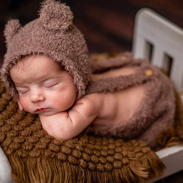 Kian joined the competition — help win amazing prizes! baby, beanie, blanket, bonnet, cap, clothing, crib, face, furniture, happy, hat, head, infantbed, newborn, person, photography, portrait, sleeping, smile